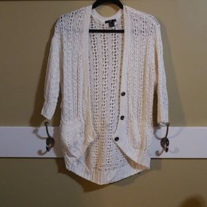 Cream knit cardigan.